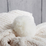 White hygee knit pom-pom blanket up close of pom-pom